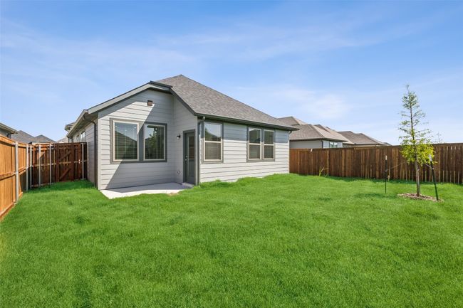 Back of house with a shingled roof and a patio | Image 19