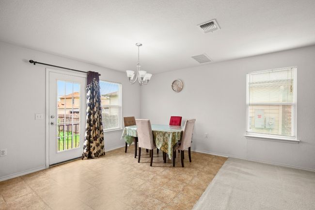 Dining area featuring a chandelier and plenty of natural light | Image 9