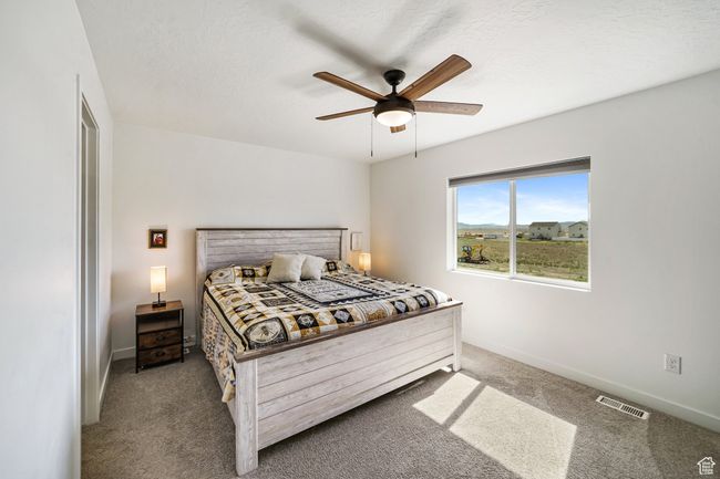 Carpeted bedroom featuring baseboards and a ceiling fan | Image 18