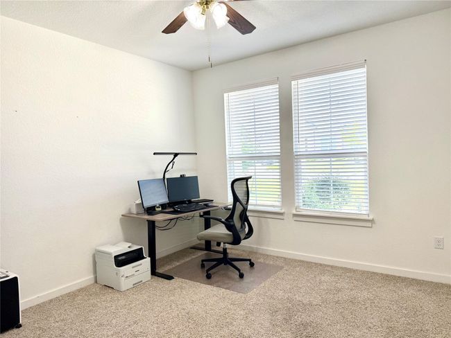 Office space with carpet, ceiling fan, and baseboards | Image 21
