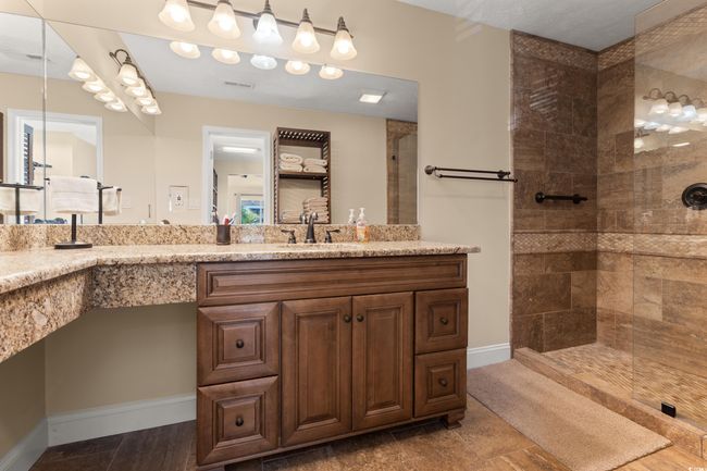 Full bath featuring a walk in shower, double vanity, and baseboards | Image 13