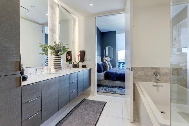 Bathroom with double vanity, a garden tub, tile patterned floors, and connected bathroom | Image 10