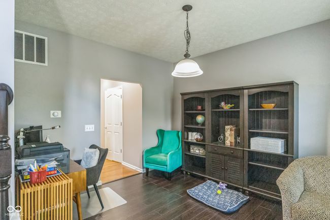 office with wood finished floors and a textured ceiling | Image 8