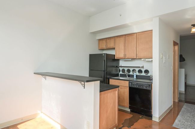 Tidy kitchen with breakfast bar and space for bar stools | Image 9
