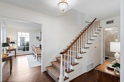 Stairs featuring a notable chandelier, ornamental molding, and hardwood / wood-style flooring | Image 3