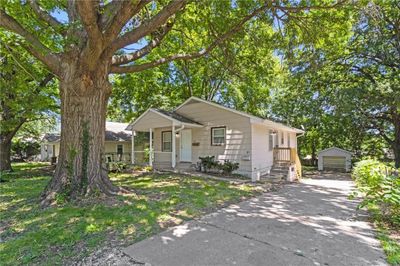 View of front of home featuring an outdoor structure and a garage | Image 2