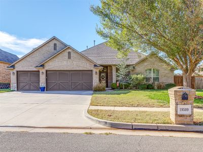 Single story home featuring a garage and a front yard | Image 1