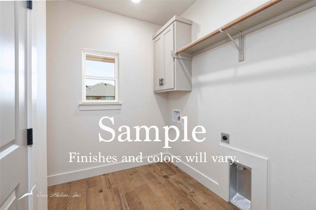 Laundry room with built in cabinets, extra room for a fridge or freezer and closet storage. | Image 10