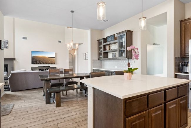 The kitchen opens up into the breakfast area and living room, making it the perfect space for both cooking and socializing | Image 14