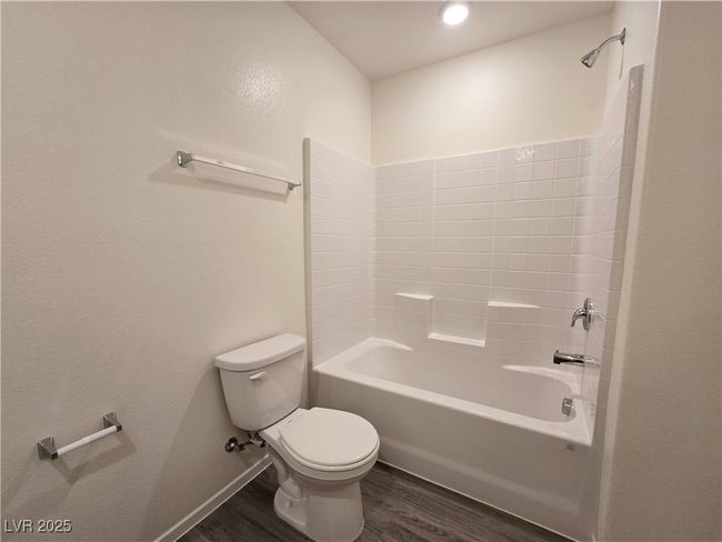 Bathroom featuring wood finished floors, toilet, and bathing tub / shower combination | Image 26