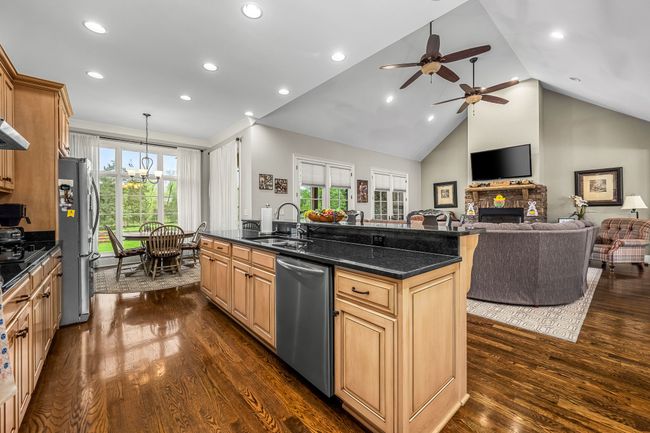 Together, these elements make the kitchen a functional and welcoming home center that's open to the family room and dining room, perfect for large gatherings. | Image 41