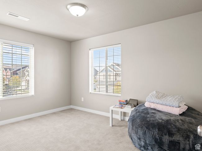 Bedroom featuring baseboards and light carpet | Image 19