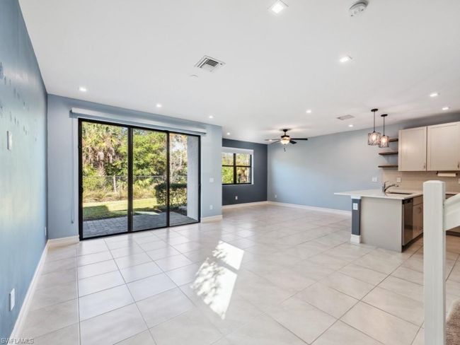 Unfurnished living room with sink, ceiling fan, and light tile patterned flooring | Image 9