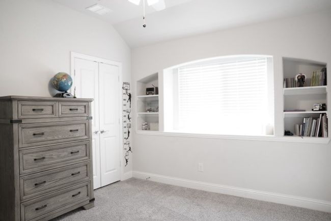 Bedroom with baseboards, light carpet, vaulted ceiling, and a closet | Image 20