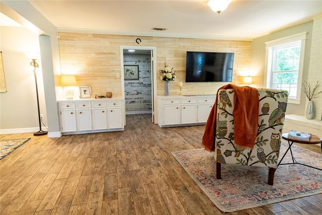 View from mid-den toward primary bedroom door, fireplace is to the right. | Image 14
