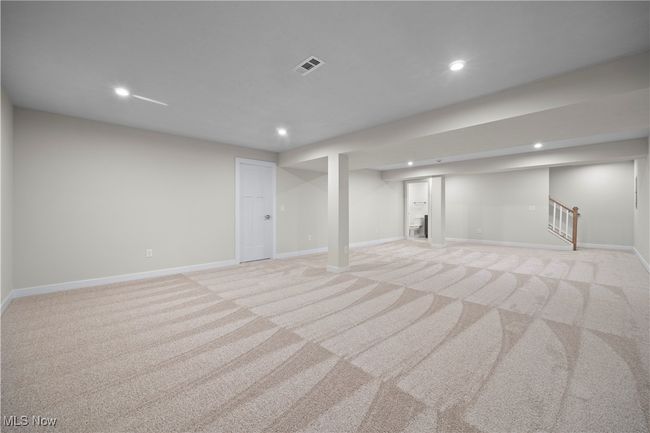 Finished basement featuring light carpet, baseboards, stairway, and recessed lighting | Image 29