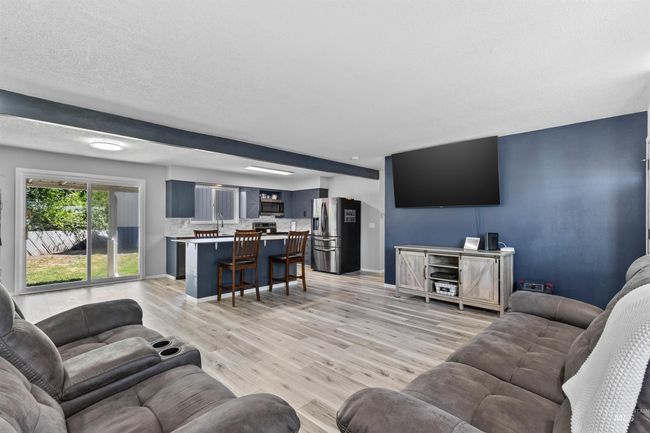 Living room featuring baseboards and light wood-type flooring | Image 6