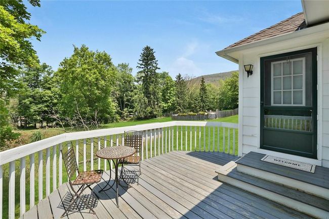 Cottage deck with view of expansive yard | Image 35