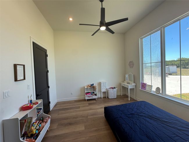 Bedroom featuring wood finished floors, recessed lighting, and ceiling fan | Image 13