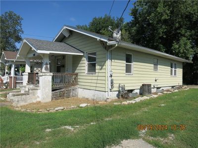 View of front of home with central AC, a front lawn, and a porch | Image 2