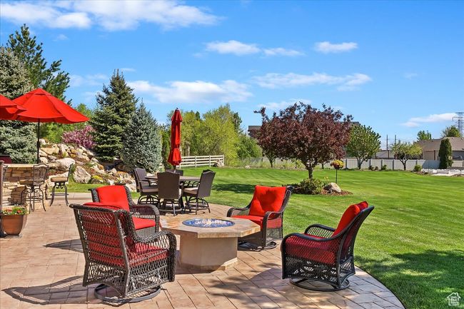 View of patio / terrace with fence, outdoor dining area, and a fire pit | Image 52
