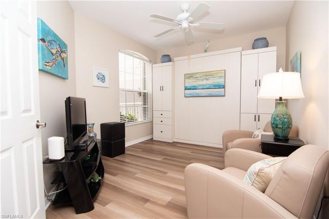 The den/office space features a stylish Murphy Bed with additional storage solutions for overflow guests. | Image 26