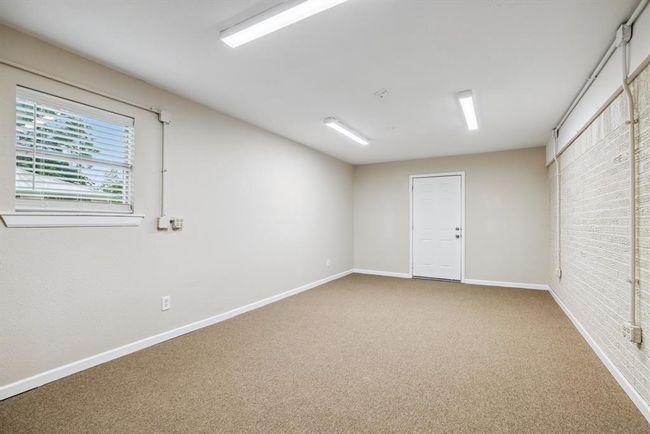 Extra room could be family room, built adjacent to the original garage. Work areas were created for the photography company. Front door and back door egress. New carpet, updated lighting and 2" blinds | Image 17