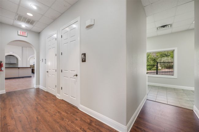 Corridor featuring a paneled ceiling, visible vents, and hardwood / wood-style flooring | Image 28