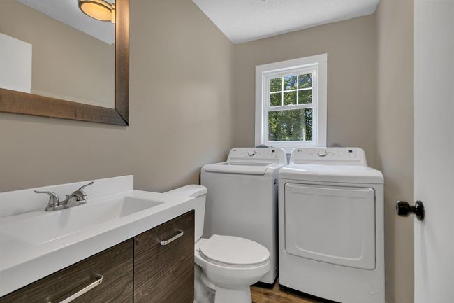 Main level half bath + laundry - new washer and dryer in 2024 | Image 13