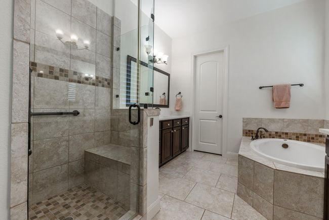 Full bath with a bath, vanity, a shower stall, and tile patterned floors | Image 14