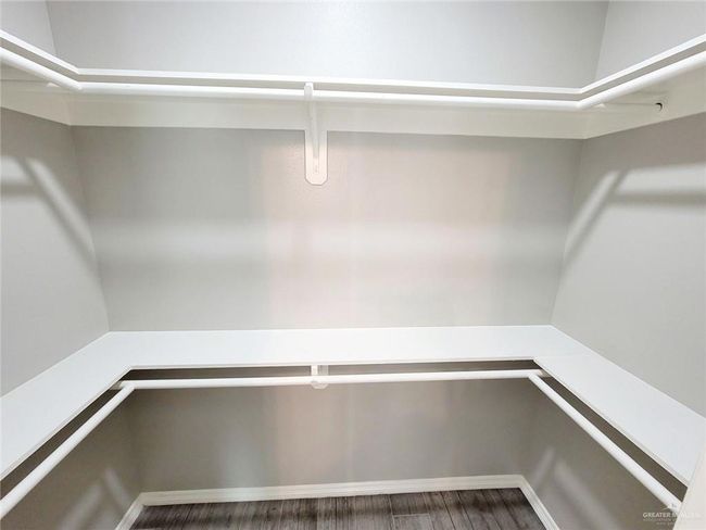 Spacious closet featuring wood finished floors | Image 15