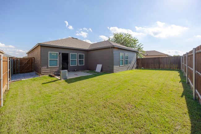 Rear view of house featuring a fenced backyard and a patio | Image 27
