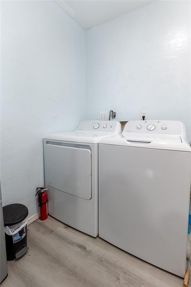 Laundry room featuring light hardwood / wood-style floors and independent washer and dryer | Image 11