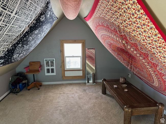 Bonus room with vaulted ceiling, carpet flooring, heating unit, and baseboards | Image 27