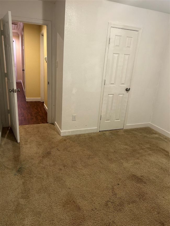 Carpeted empty room with baseboards | Image 12