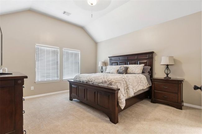 Spacious primary bedroom with high ceilings and new carpet. | Image 14