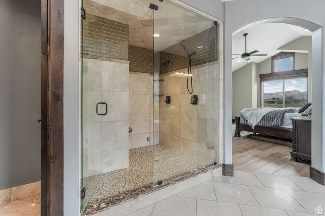 Spa Inspired Primary Bathroom retreat show casing walk in steam shower with limestone, calcutta gold marble and quartz countertops. | Image 8