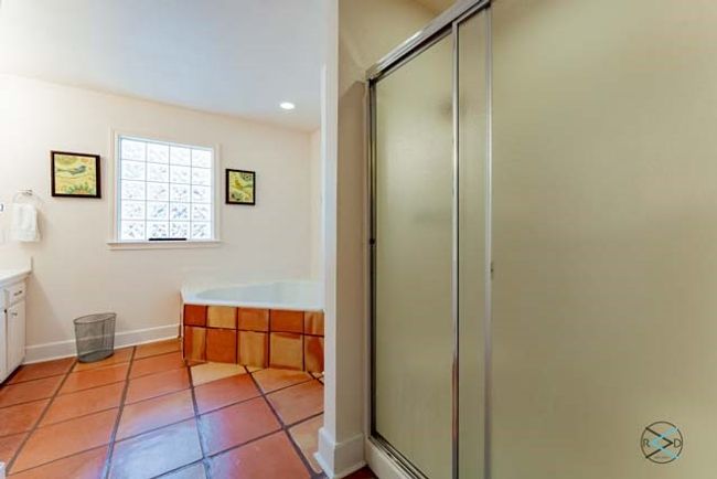 Ensuite bath offers his and her closets, separate shower and jetted tub. | Image 15