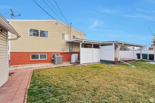 Back of property featuring central AC unit, a yard, and fence | Image 23