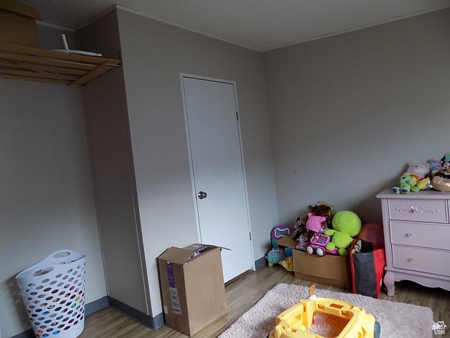 Bedroom with light hardwood / wood-style floors | Image 13