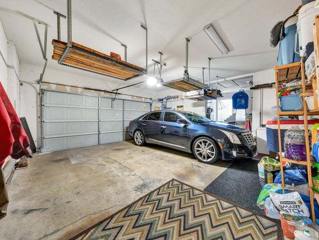 Garage featuring a garage door opener. The 3rd garage was not photographed | Image 31