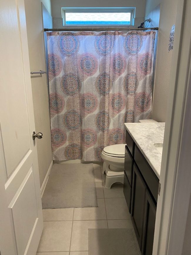 Bathroom featuring toilet, vanity, tile patterned flooring, and plenty of natural light | Image 12