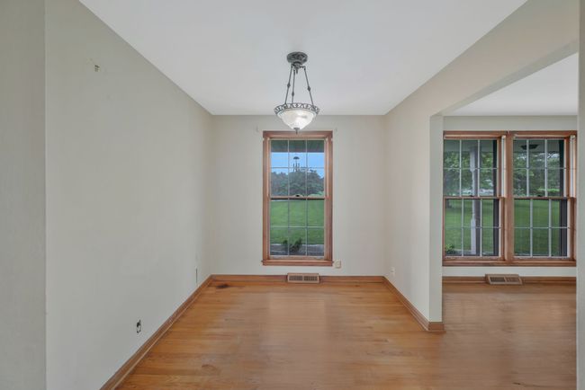 FORMAL DINING ROOM WITH FLOOR TO CEILING WINDOW AND CHANDELIER. | Image 16