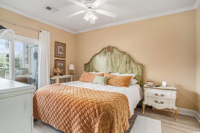 Bedroom featuring access to exterior, ornamental molding, light wood-type flooring, and a ceiling fan | Image 12