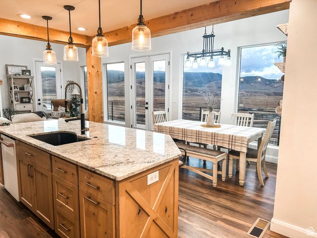 Kitchen with baseboards, beamed ceiling, a sink, and dark wood-type flooring | Image 12