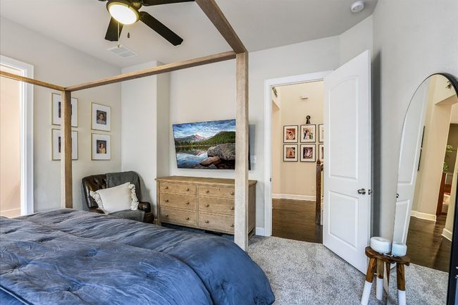 Carpeted bedroom featuring visible vents, baseboards, and a ceiling fan | Image 17