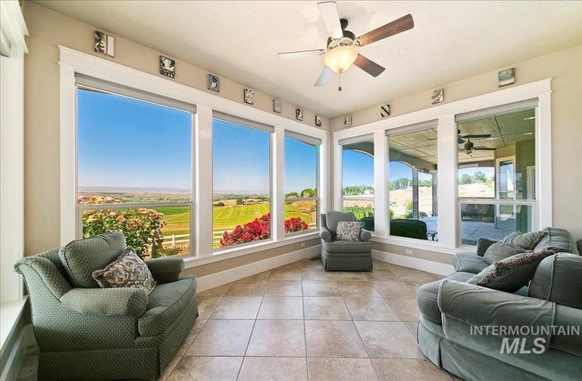 Sunroom with baseboards and tile patterned floors | Image 15
