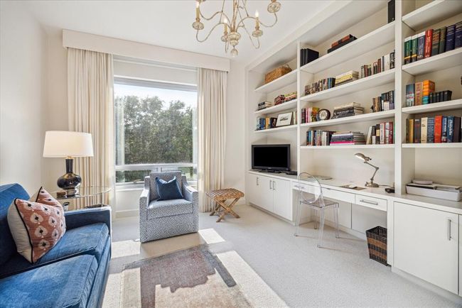 This view of the second bedroom shows the built in desk and great shelf space. | Image 25