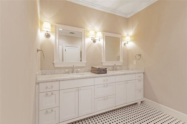 Bathroom featuring ornamental molding, double vanity, and baseboards | Image 15