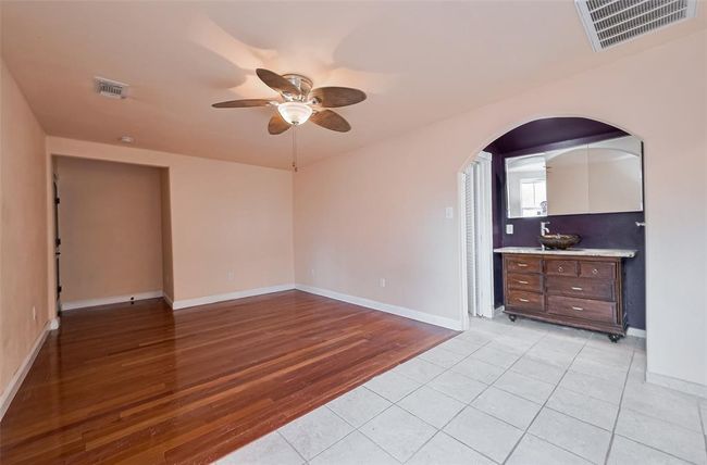 Flexible living space with wood and tile flooring offers an open layout that transitions into a second kitchen—ideal for multi-generational living. | Image 39